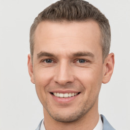 Joyful white young-adult male with short  brown hair and brown eyes