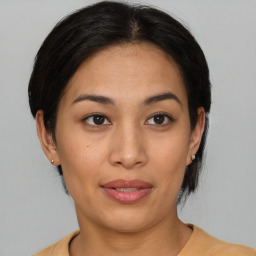 Joyful asian young-adult female with medium  brown hair and brown eyes