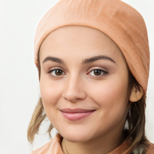 Joyful white young-adult female with medium  brown hair and brown eyes