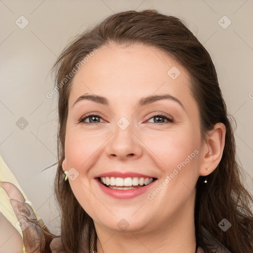 Joyful white young-adult female with long  brown hair and brown eyes