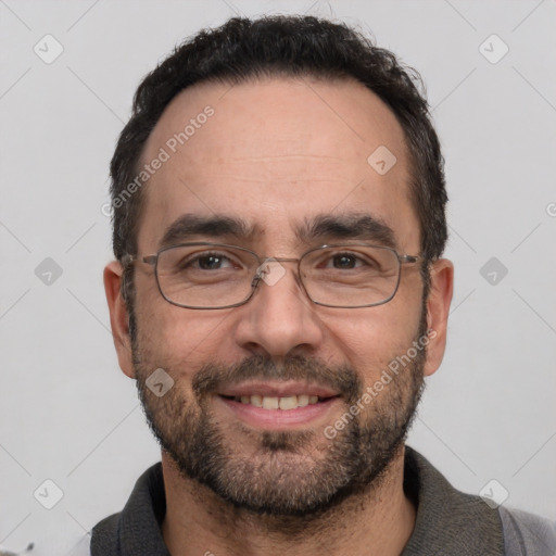 Joyful white adult male with short  black hair and brown eyes