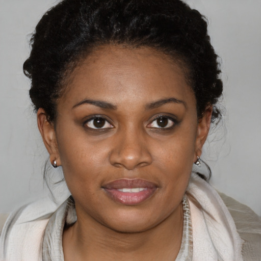 Joyful black young-adult female with medium  brown hair and brown eyes