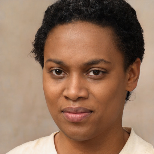 Joyful black young-adult female with short  brown hair and brown eyes