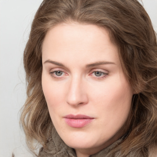 Joyful white young-adult female with long  brown hair and green eyes