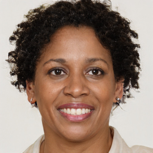 Joyful black adult female with short  brown hair and brown eyes