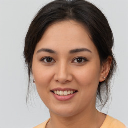 Joyful asian young-adult female with medium  brown hair and brown eyes