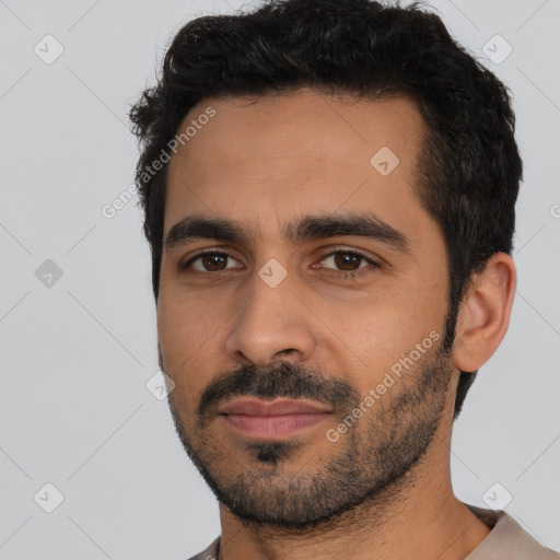 Joyful latino young-adult male with short  black hair and brown eyes