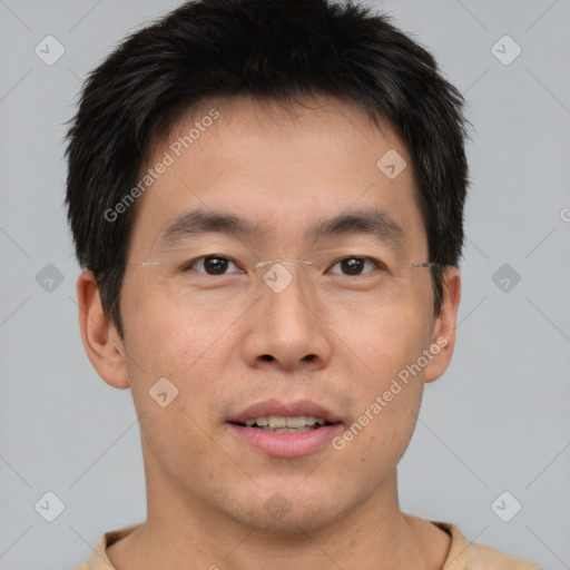 Joyful asian young-adult male with short  brown hair and brown eyes