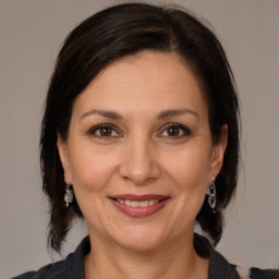 Joyful white adult female with medium  brown hair and brown eyes