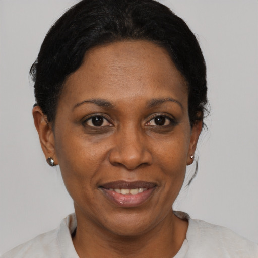 Joyful black adult female with short  black hair and brown eyes