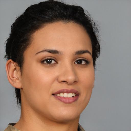 Joyful latino young-adult female with short  brown hair and brown eyes