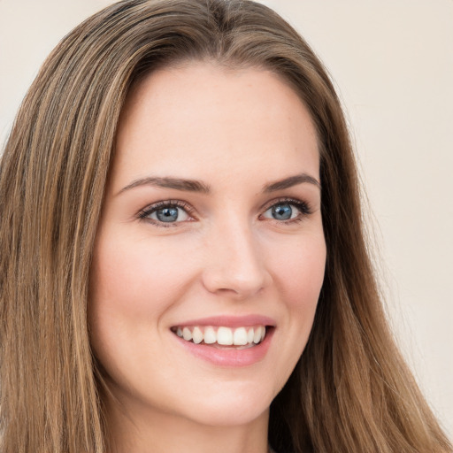 Joyful white young-adult female with long  brown hair and green eyes