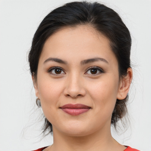 Joyful latino young-adult female with medium  brown hair and brown eyes