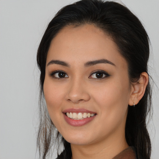 Joyful white young-adult female with long  black hair and brown eyes