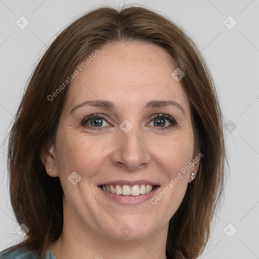 Joyful white adult female with medium  brown hair and grey eyes