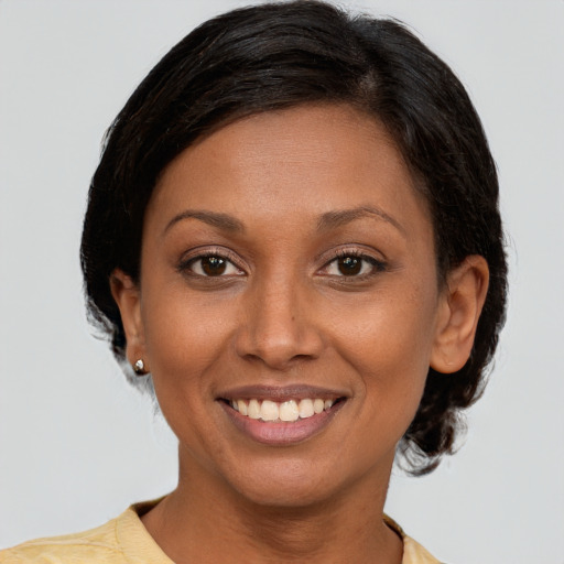 Joyful latino young-adult female with short  brown hair and brown eyes