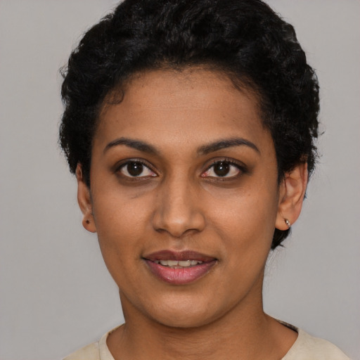 Joyful latino young-adult female with short  black hair and brown eyes