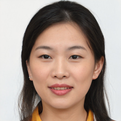 Joyful asian young-adult female with long  brown hair and brown eyes