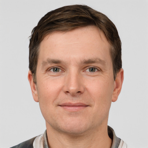 Joyful white adult male with short  brown hair and grey eyes