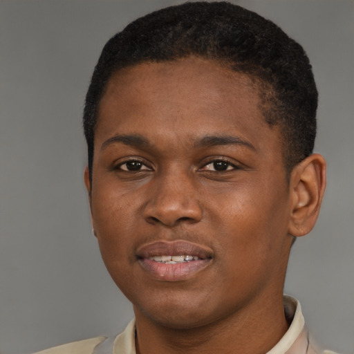 Joyful black young-adult male with short  brown hair and brown eyes