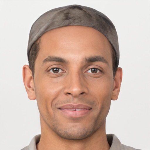 Joyful white young-adult male with short  black hair and brown eyes