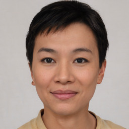 Joyful asian young-adult female with short  black hair and brown eyes