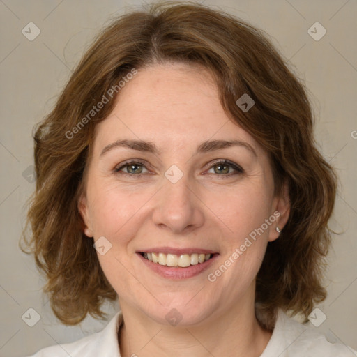 Joyful white adult female with medium  brown hair and green eyes