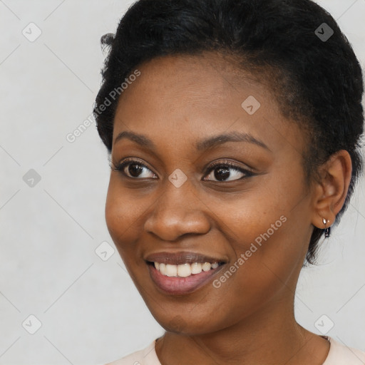 Joyful black young-adult female with short  black hair and brown eyes