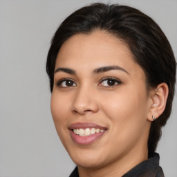 Joyful latino young-adult female with medium  brown hair and brown eyes