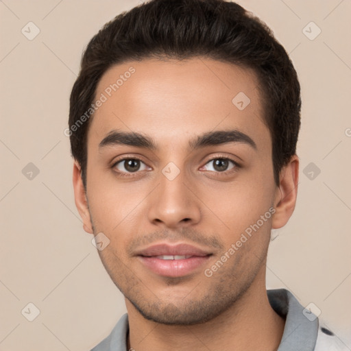 Joyful white young-adult male with short  black hair and brown eyes