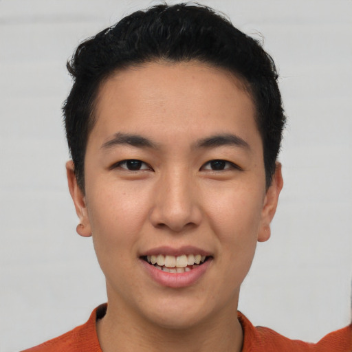 Joyful asian young-adult male with short  black hair and brown eyes