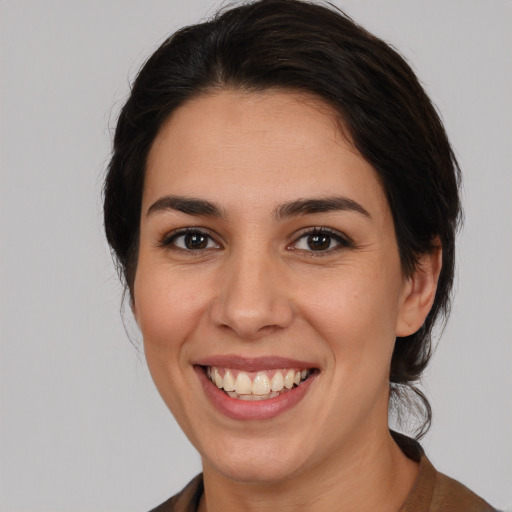 Joyful white young-adult female with medium  brown hair and brown eyes