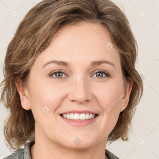 Joyful white young-adult female with medium  brown hair and green eyes