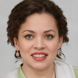 Joyful white young-adult female with medium  brown hair and green eyes