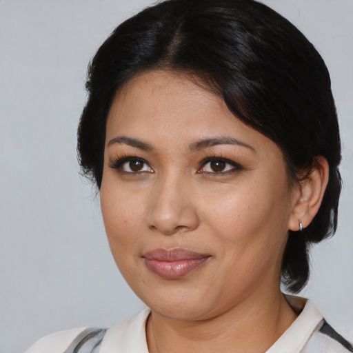 Joyful latino young-adult female with medium  black hair and brown eyes
