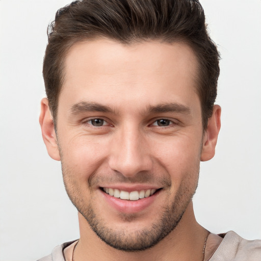 Joyful white young-adult male with short  brown hair and brown eyes