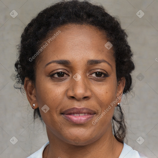 Joyful black adult female with medium  brown hair and brown eyes