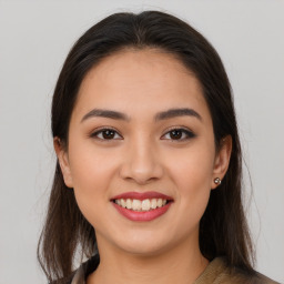 Joyful latino young-adult female with long  brown hair and brown eyes