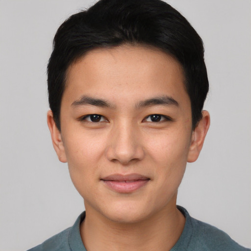 Joyful asian young-adult male with short  black hair and brown eyes