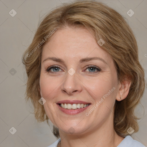 Joyful white adult female with medium  brown hair and blue eyes