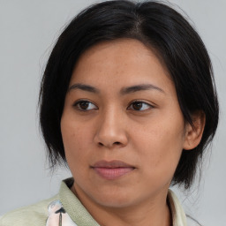 Joyful asian young-adult female with medium  brown hair and brown eyes