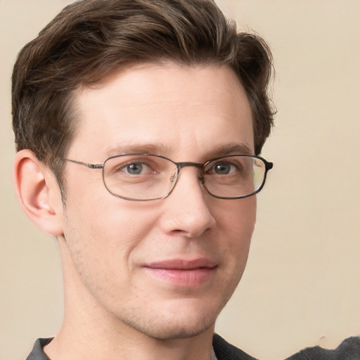 Joyful white adult male with short  brown hair and grey eyes