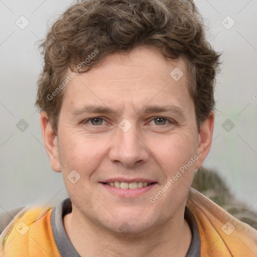 Joyful white adult male with short  brown hair and grey eyes