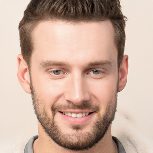 Joyful white young-adult male with short  brown hair and brown eyes