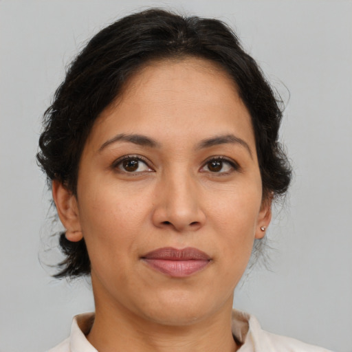 Joyful latino adult female with medium  brown hair and brown eyes