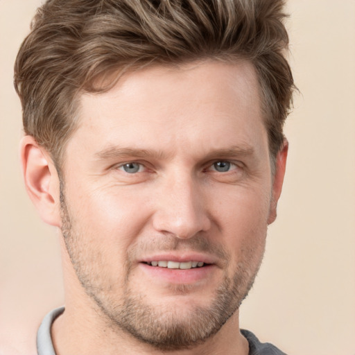 Joyful white adult male with short  brown hair and grey eyes