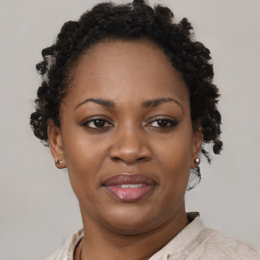 Joyful black adult female with short  brown hair and brown eyes