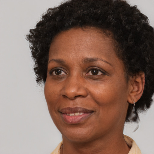 Joyful black adult female with short  brown hair and brown eyes