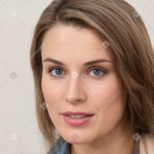 Joyful white young-adult female with long  brown hair and blue eyes