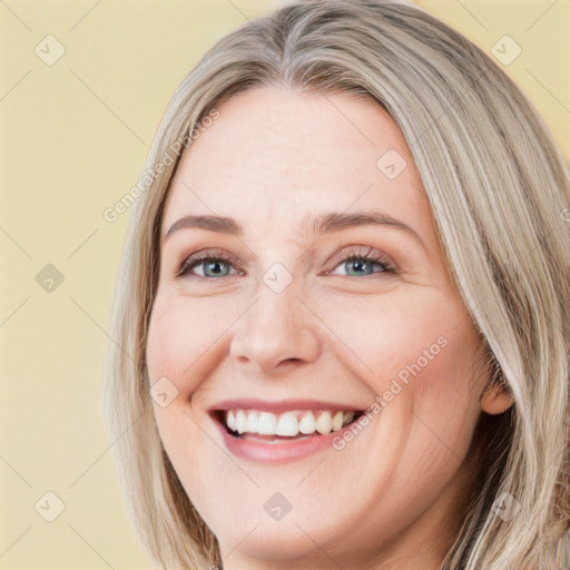 Joyful white young-adult female with long  brown hair and blue eyes